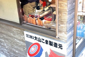<p>A tops craftsman creating a new souvenir</p>