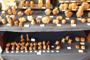 <p>Wooden craft goods for sale in one of the garden's shops</p>